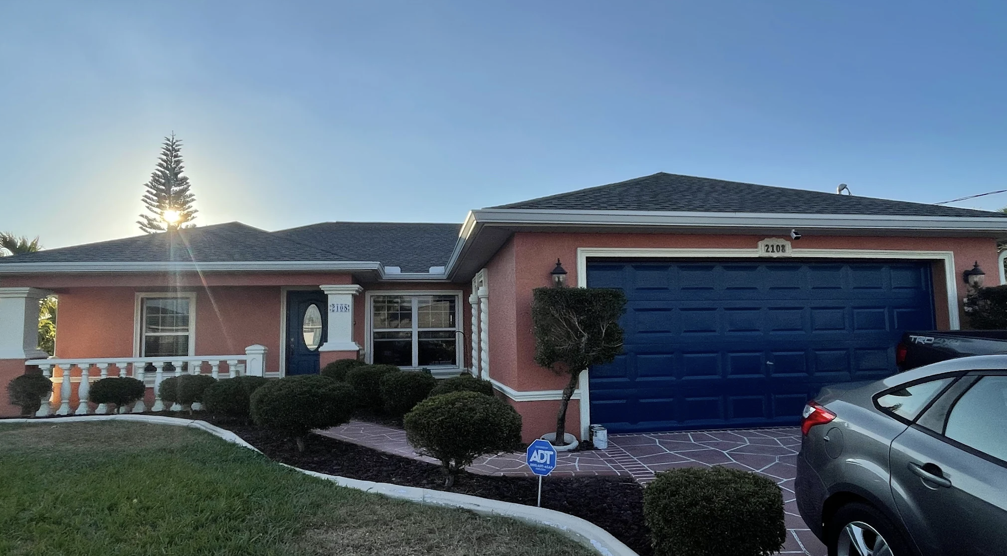 Apex Painting Group exterior painting project with freshly painted garage door and stucco home