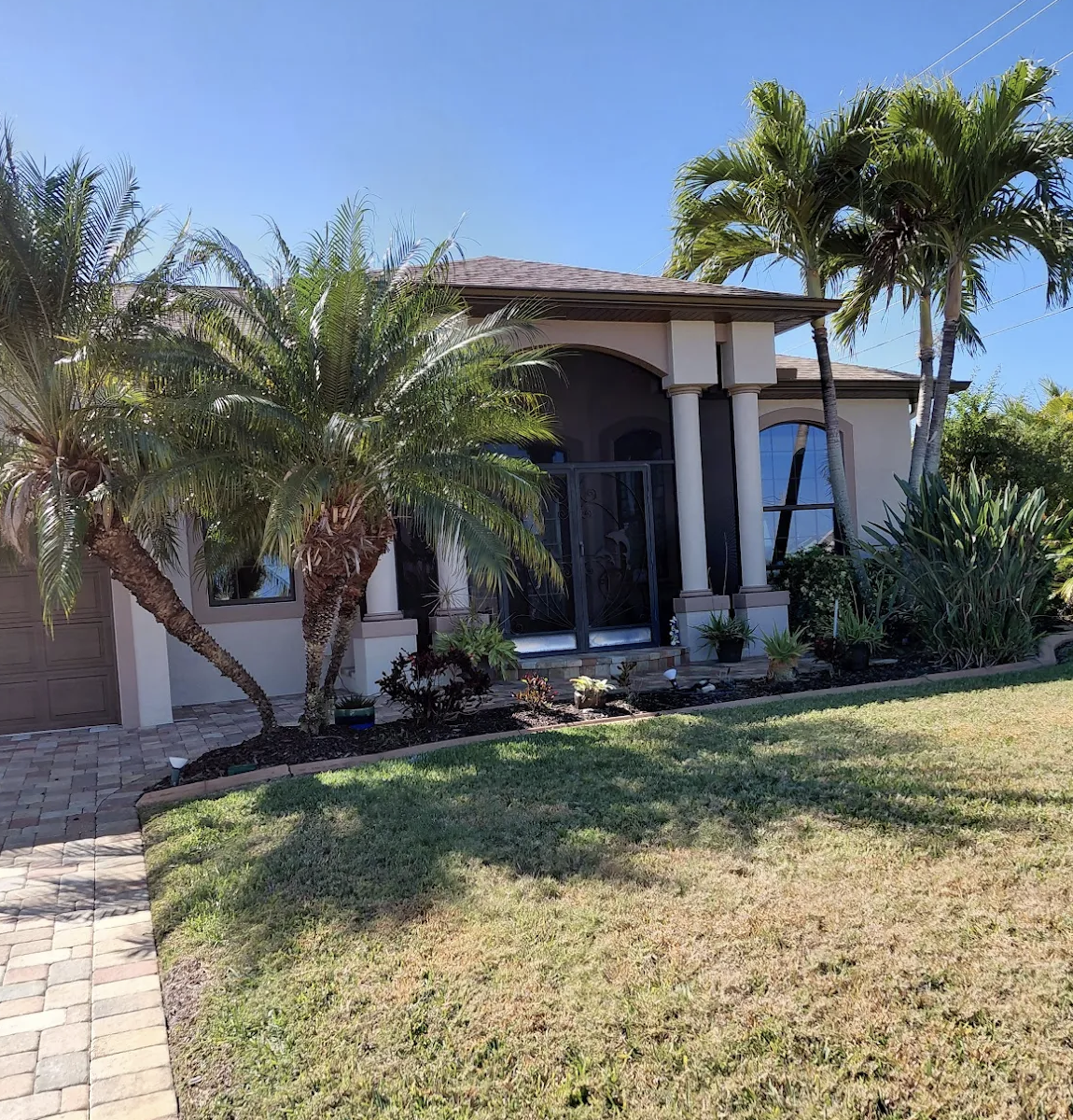 Freshly painted garage doors and trim on a Bonita Springs home