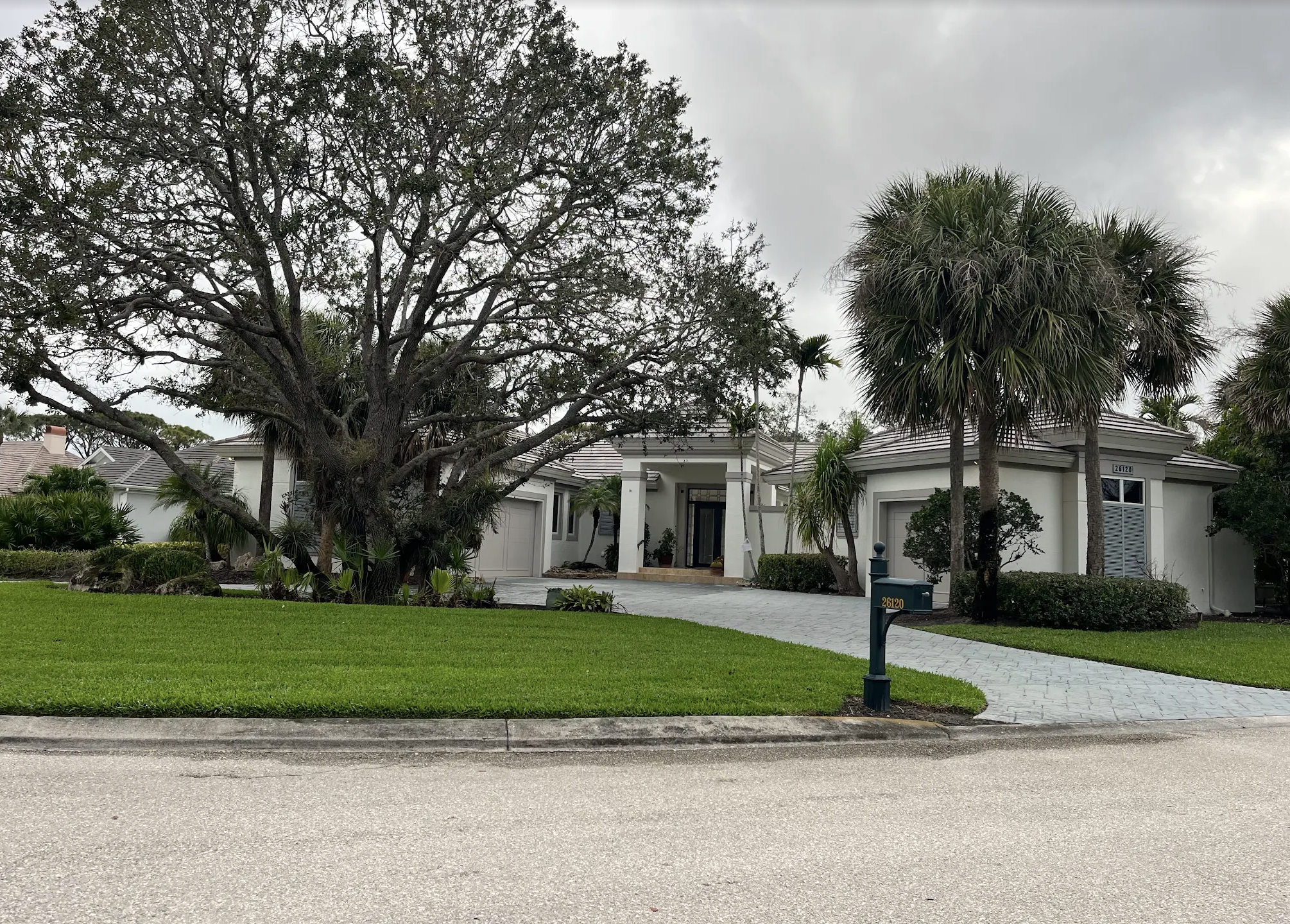 Painted Bonita Bay home with finished garage doors, entry, and exterior