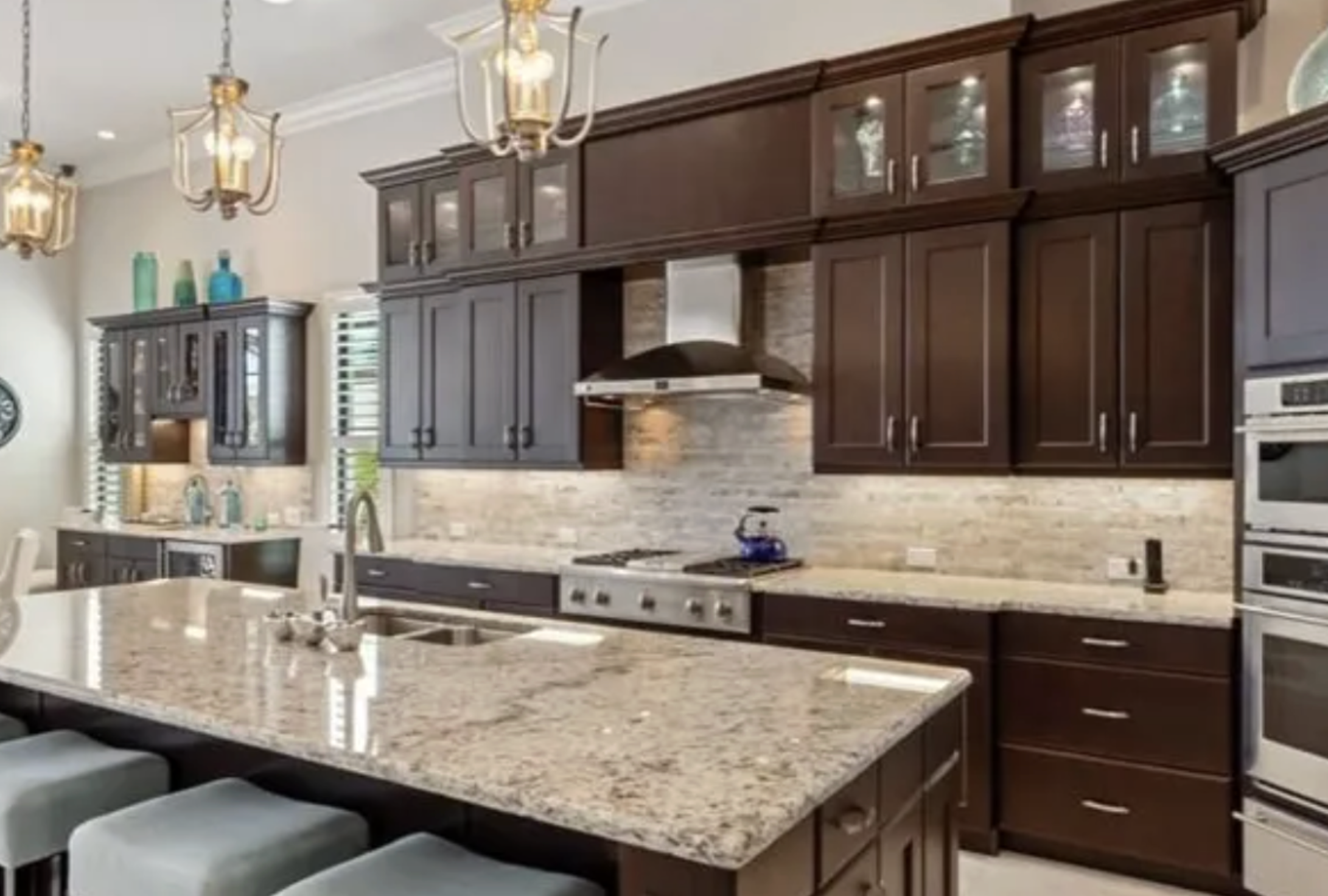 Kitchen before full cabinet repainting in Miromar Lakes