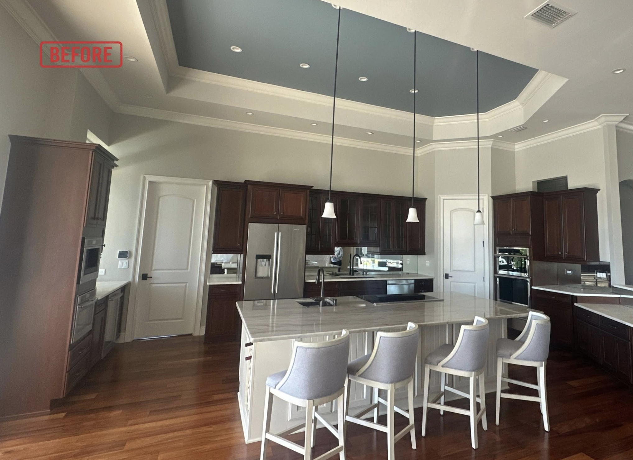 Dark wood kitchen cabinets before painting in a Verandah home in Fort Myers