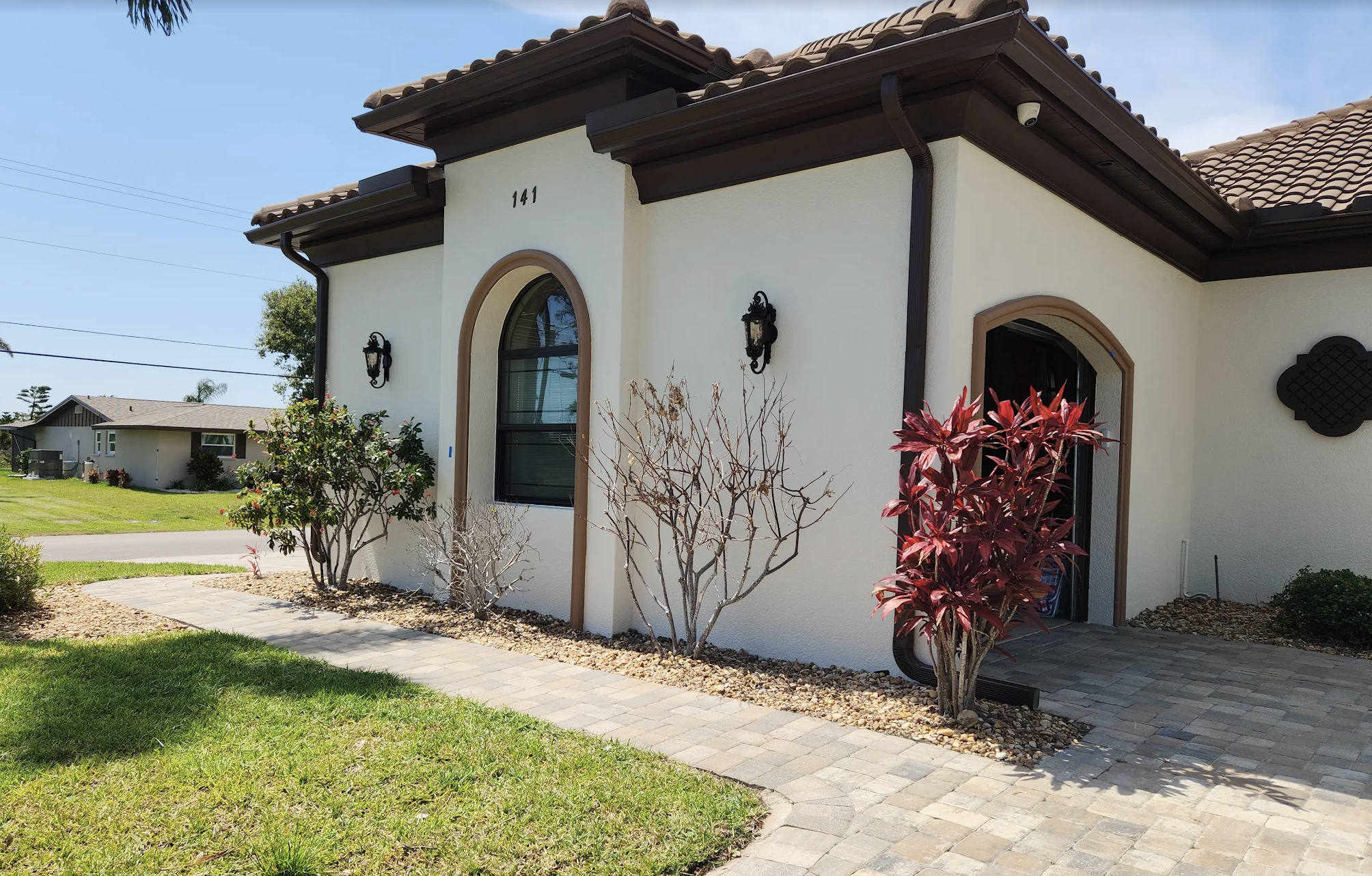 Exterior painting details on an arched stucco home in Pelican Cape Coral