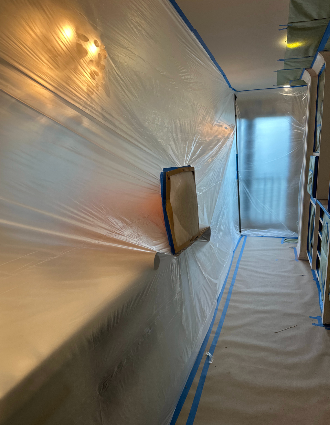 Kitchen surfaces and flooring protected before cabinet painting on Gulf Shore Boulevard in Naples