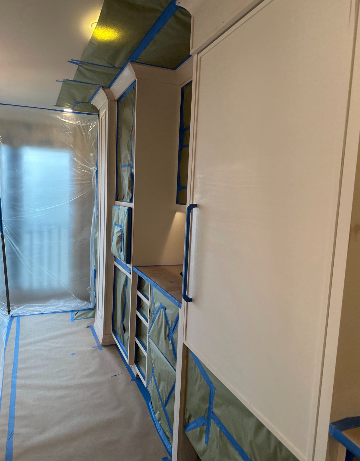 Cabinet frames masked and prepared for painting in a Naples penthouse on Gulf Shore Boulevard