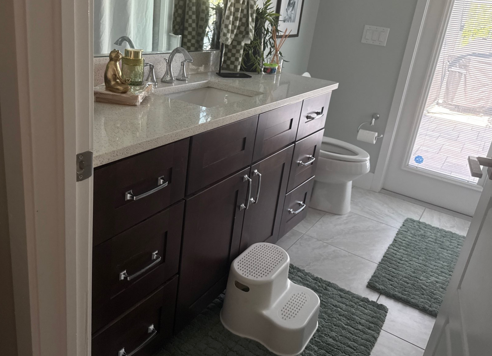 Dark wood bathroom vanity before cabinet painting in Southwest Cape Coral