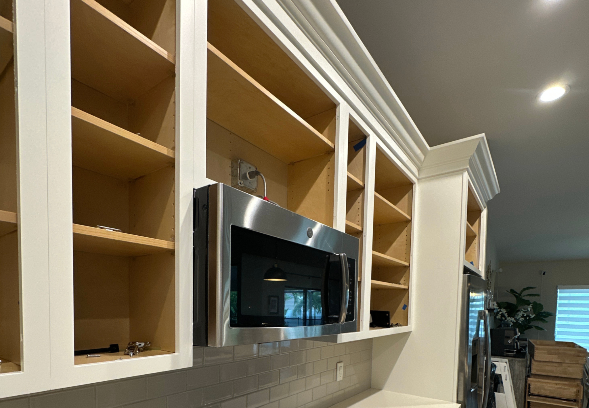 Kitchen cabinet frames with doors removed during cabinet painting in Southwest Cape Coral
